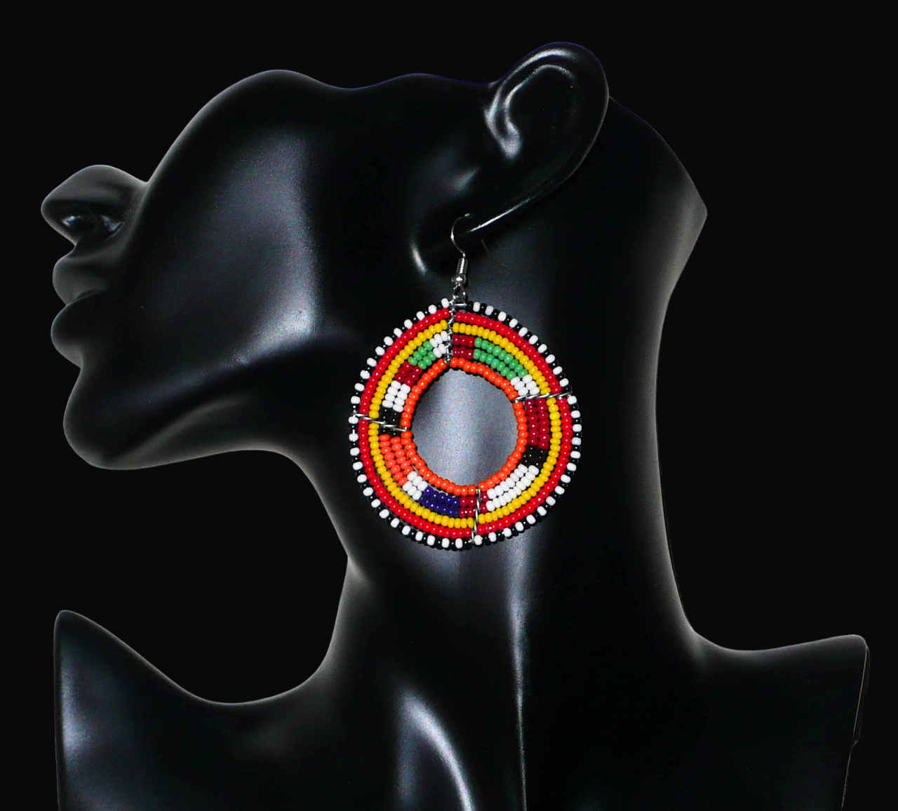 Boucles d'oreilles africaines Massai aux accents afro chic des années 70 composées de perles de rocaille orange et multicolores glissées sur des structures circulaires en fils de fer. De taille moyenne, elles mesurent 7 cm de long et 5 cm de large, et se portent sur des oreilles percées.
