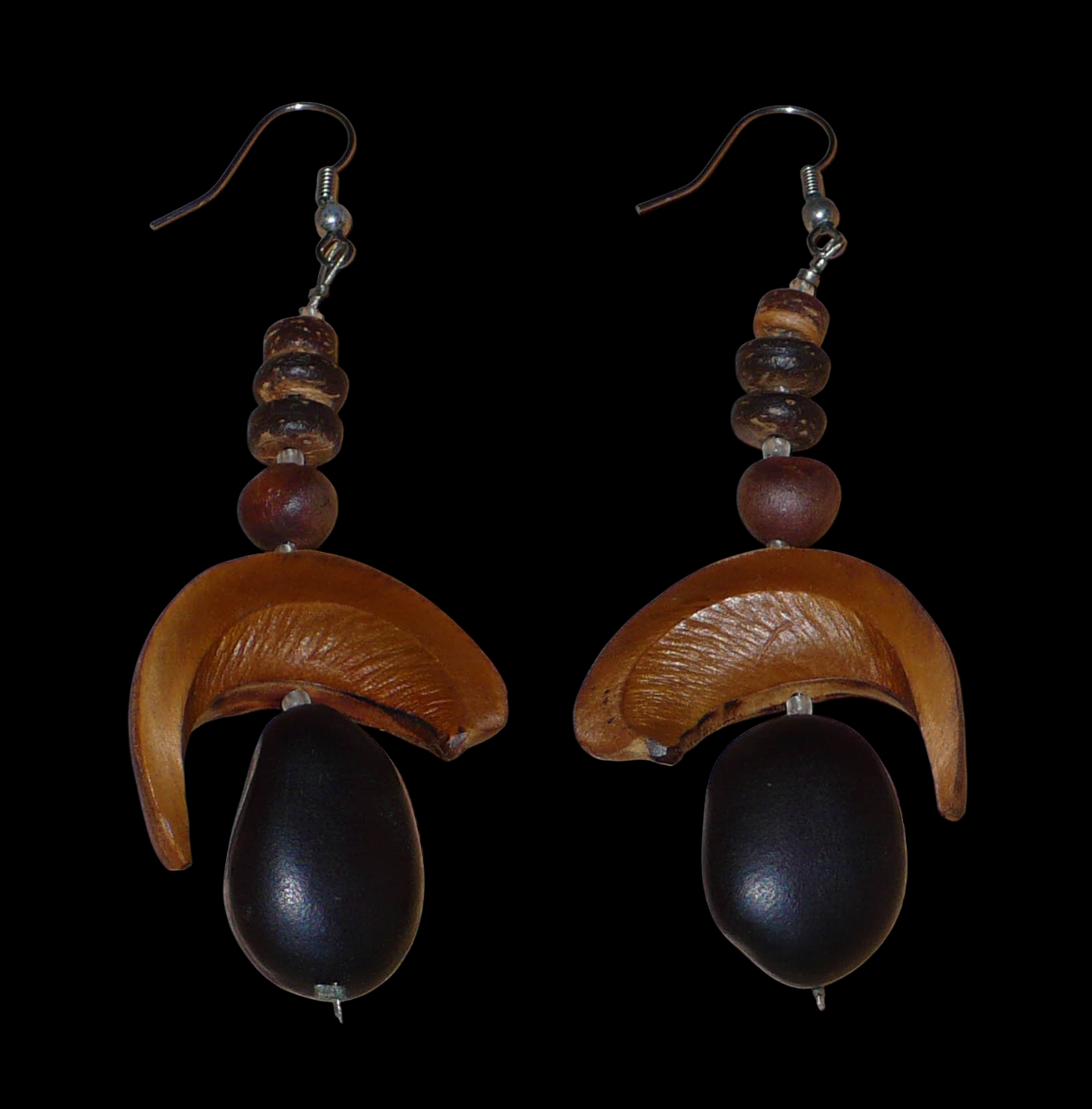 Boucles d'oreilles afro-caribéennes aux accents tropicaux composées de perles et de graines exotiques. Elles mesurent 8.5 cm de long et 3.5 cm de large, et se portent sur des oreilles percées.