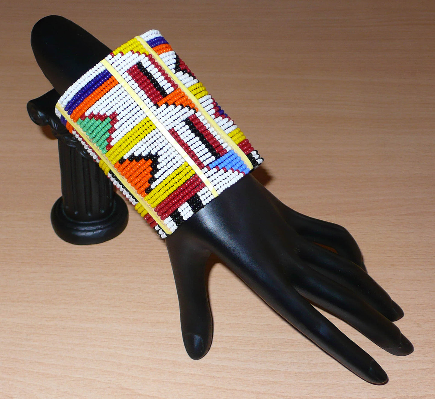 Bracelet africain traditionnel multi-rangs aux couleurs vives et motifs géométriques Massai composé de trente-six rangées de perles de rocaille blanches et multicolores.
