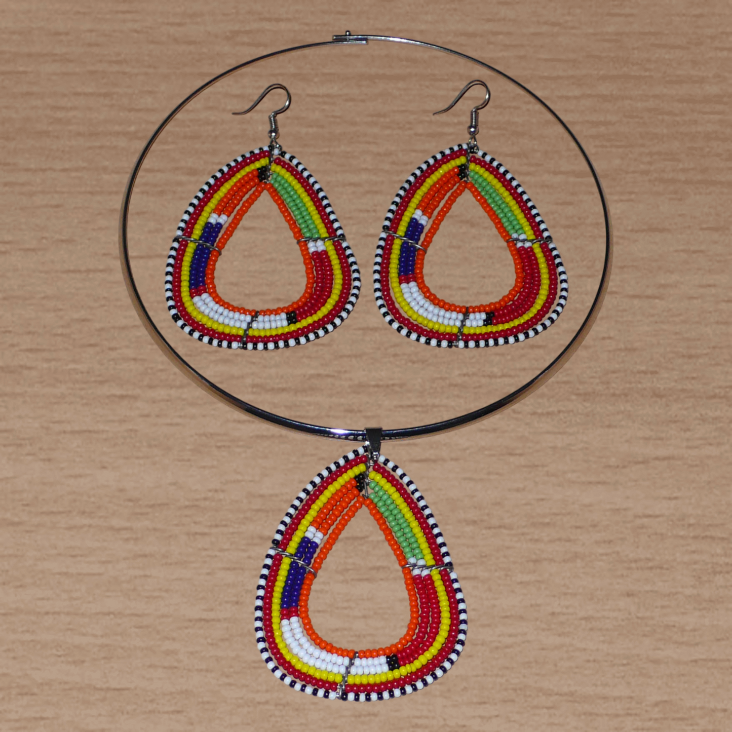 Parure de bijoux africains Massai aux accents afro chic des années 70 comprenant un collier ras-de-cou en laiton orné d'un pendentif de forme triangulaire fait de perles de rocaille orange et multicolores, et une paire boucles d'oreilles assorties.