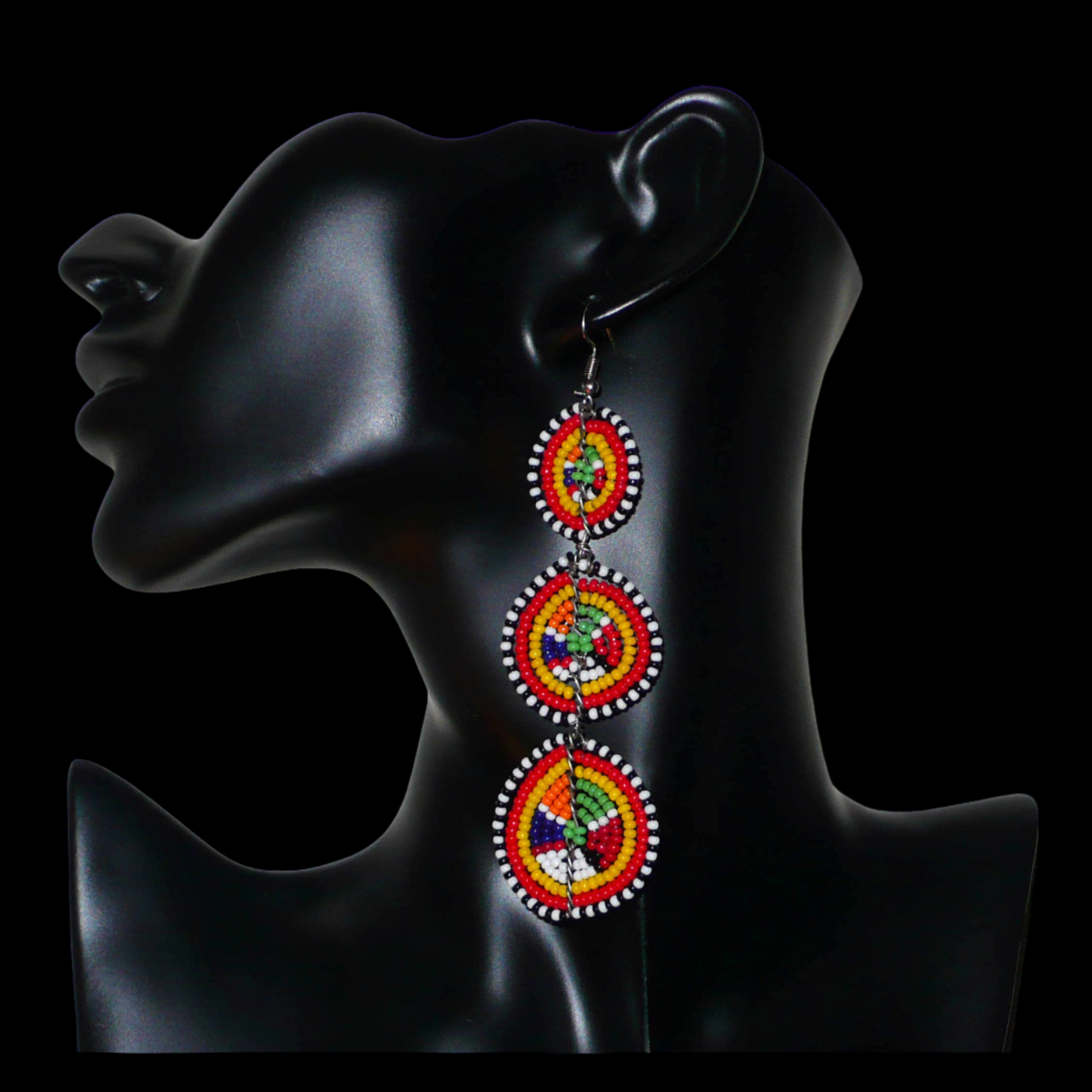 Affirmez votre style avec ces boucles d'oreilles africaines traditionnelles de confection artisanale Massai, évoquant le style afro chic des années 70. Elles se composent de perles de rocaille multicolores enfilées sur des fils de fer montés en forme de trois cercles superposés. Ces boucles d'oreilles mesurent 11 cm de long et 3.5 cm de large ; elles se portent avec des crochets en acier inoxydable sur des oreilles percées.