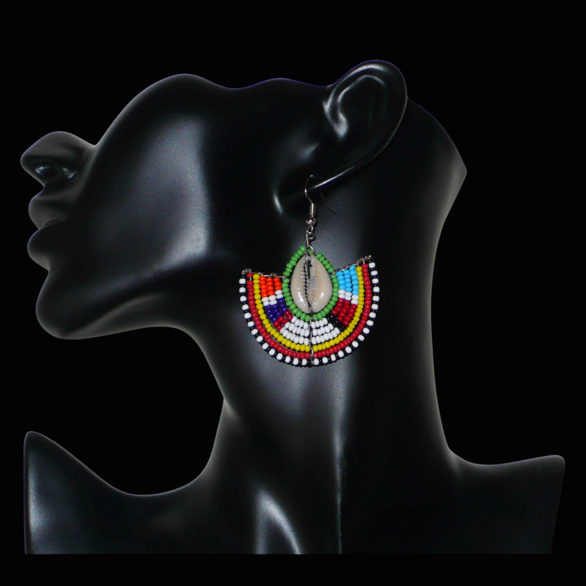 Ajoutez une touche afro chic à votre style avec cette jolie paire de boucles d'oreilles africaines issues de l'artisanat traditionnel Massai. Ces boucles d'oreilles aux accents exotiques se composent de perles de rocaille vertes et multicolores et de coquillages cauris. De taille moyenne, elles mesurent 6 cm de long et 4.5 cm de large, et se portent avec des crochets en acier inoxydable sur des oreilles percées.