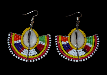 Ces jolies boucles d'oreilles à l'allure ethnique afro chic se composent de perles de rocaille jaunes et multicolores et de coquillages cauris. De taille moyenne, elles mesurent 6 cm de long et 4.5 cm de large, et se portent avec des crochets en acier inoxydable sur des oreilles percées.