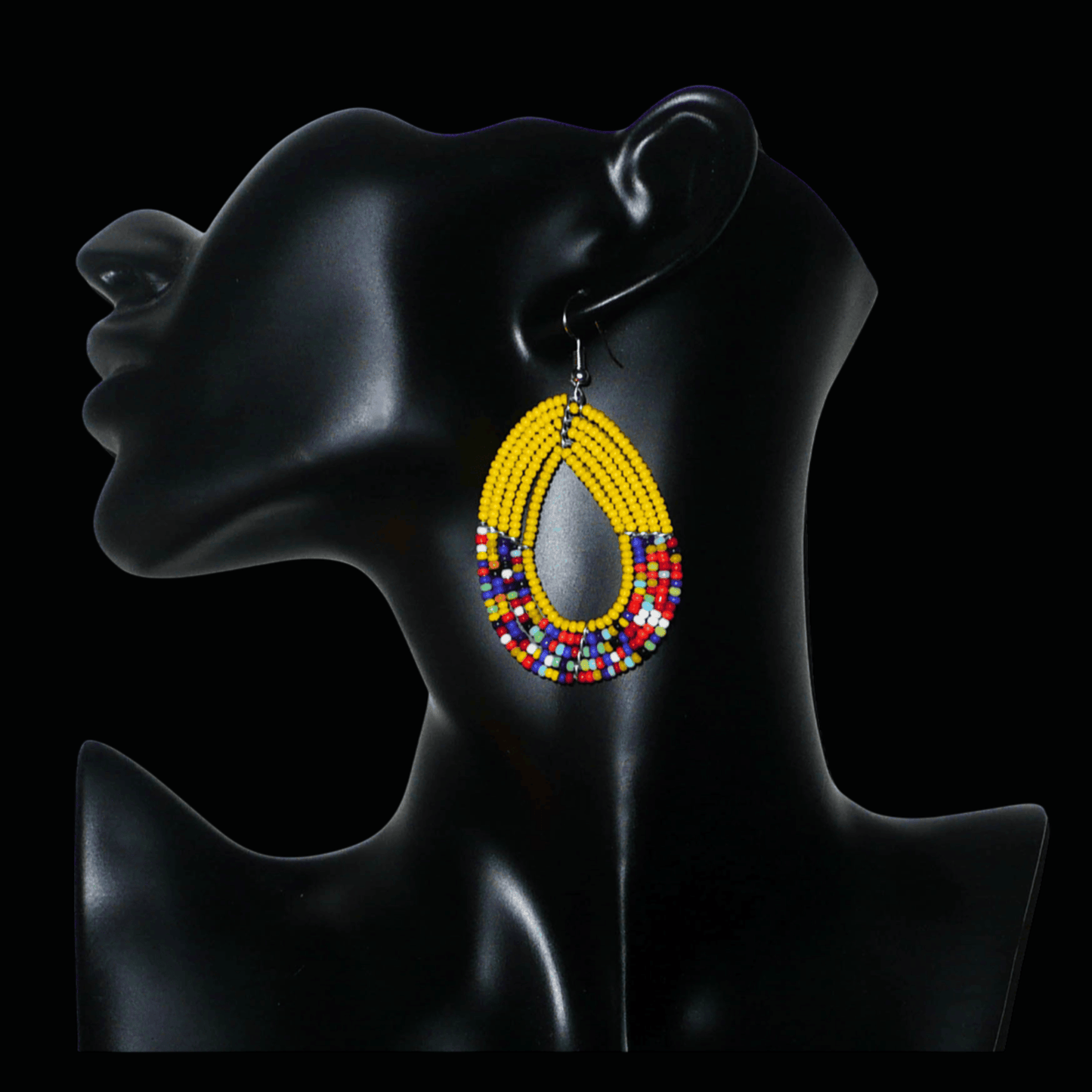 Boucles d'oreilles multi-rangs jaunes et multicolores faites de perles de rocaille enfilées sur cinq rangées de fils de fer montés en forme de gouttes. Elles mesurent 7 cm de long et 3,5 cm de large et se portent sur des oreilles percées.