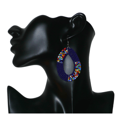 Boucles d'oreilles kenyanes multi-rangs en forme de gouttes faites de perles de rocaille bleu foncé et multicolores. Elles mesurent 7 cm de long et 4.5 cm de large, et se portent sur des oreilles percées.