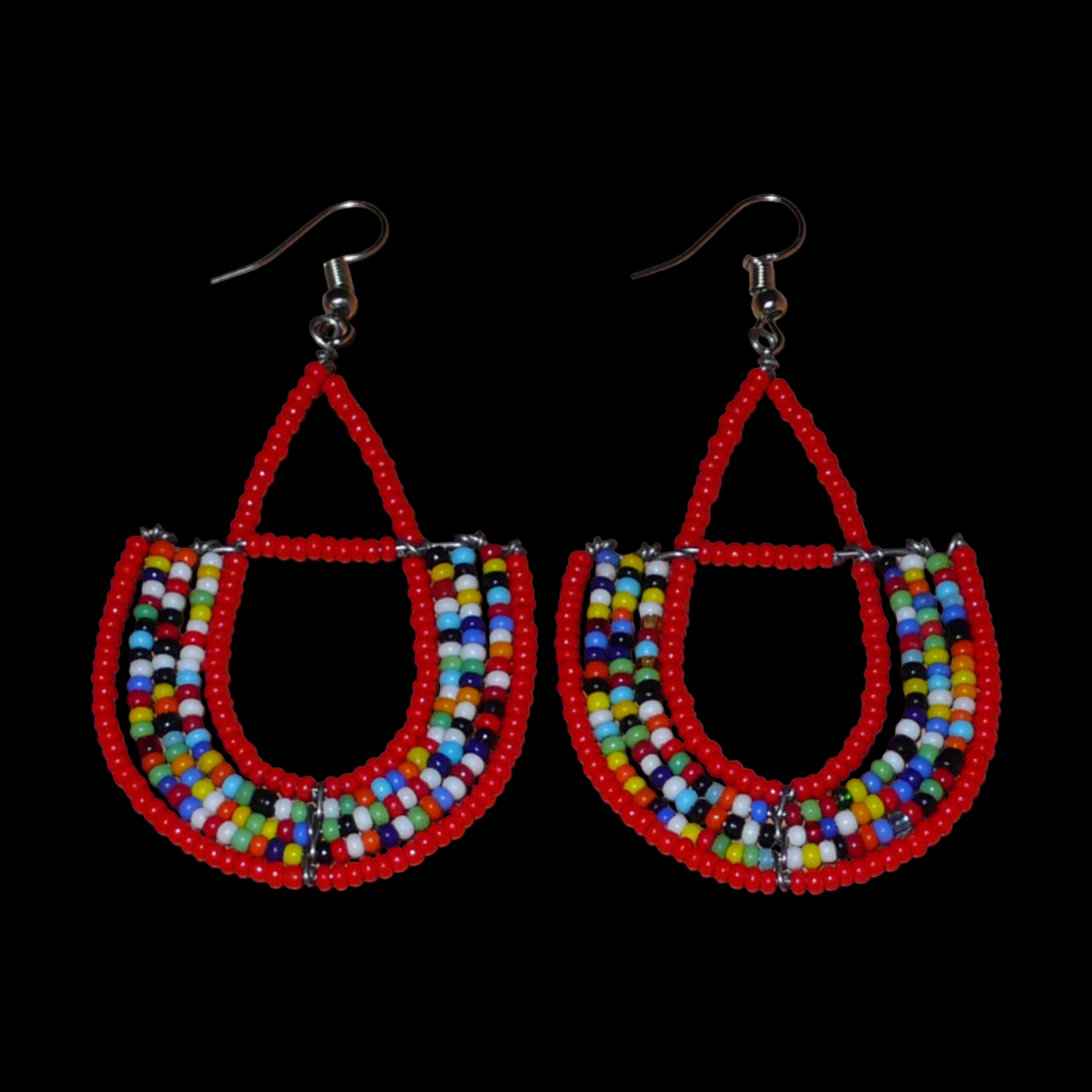 Boucles d'oreilles africaines rouges et multicolores en forme d'ancres. Elles mesurent 7,5 cm de long et 4 cm de large et se portent avec des crochets en acier inoxydable sur des oreilles percées.