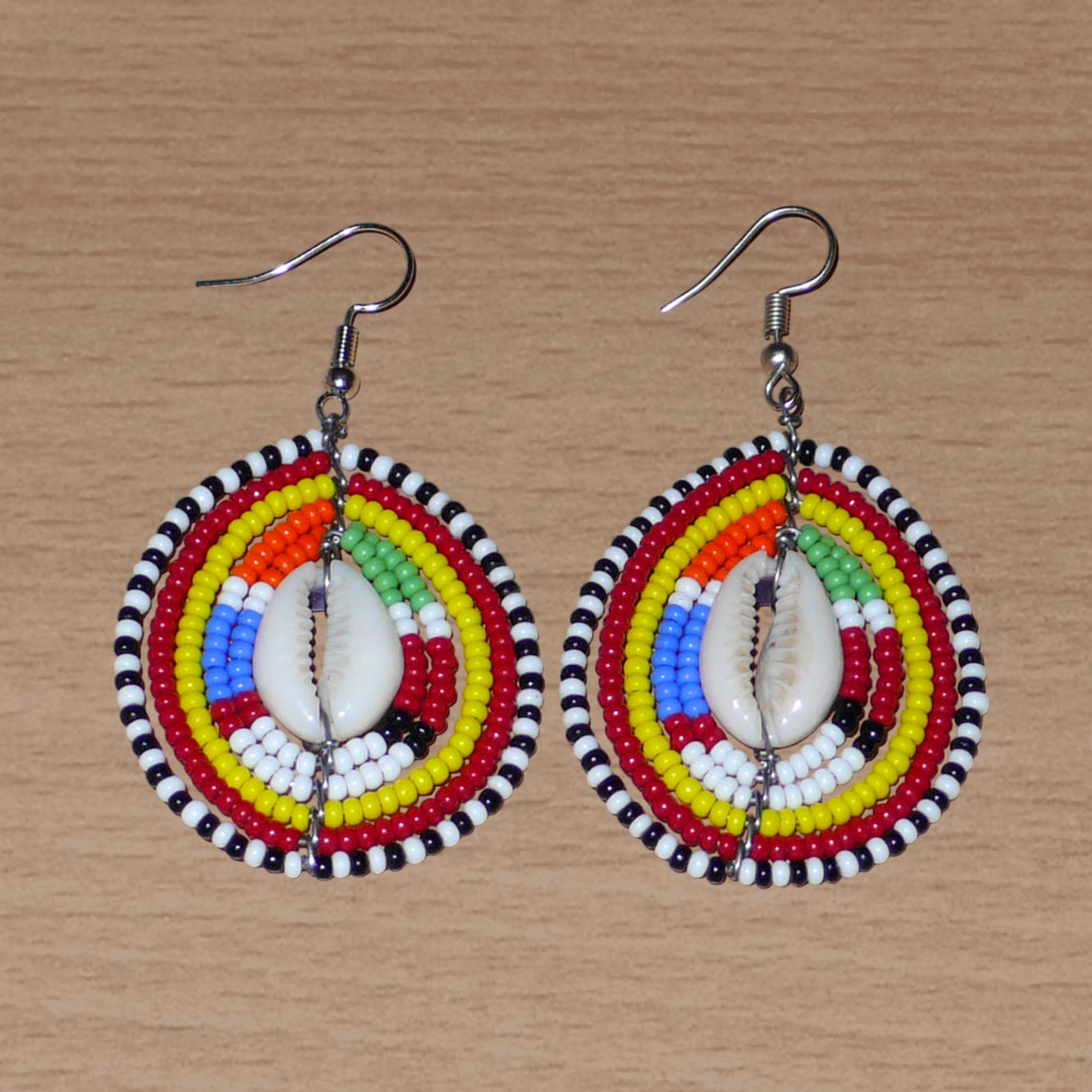 Boucles d'oreilles africaines traditionnelles Massai en perles multicolores et coquillages cauris. Elles mesurent 6.5 cm de long et 4 cm de large.