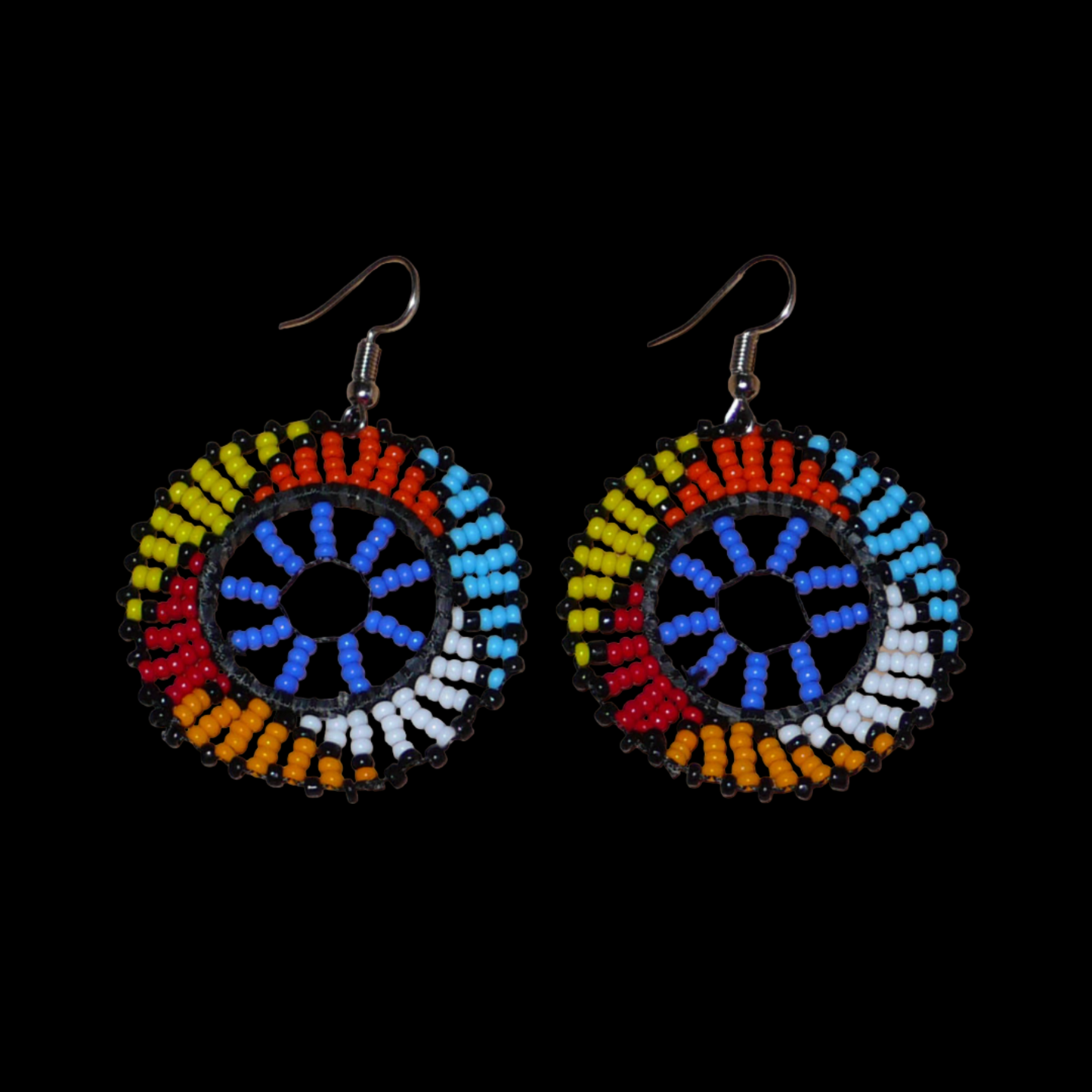 Boucles d'oreilles africaines rondes à motifs ethniques zoulous composées de perles de rocaille bleues et multicolores. De taille moyenne et légères à porter, elles mesurent 6 cm de long et 4 cm de large. Elles se portent avec des crochets en acier inoxydable sur des oreilles percées.