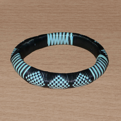 Bracelet africain noir et bleu à motifs ethniques rayés et à damiers, fabriqué au Burkina Faso dans une optique artisanale eco-responsable, composé de fines bandes de plastique recyclé.