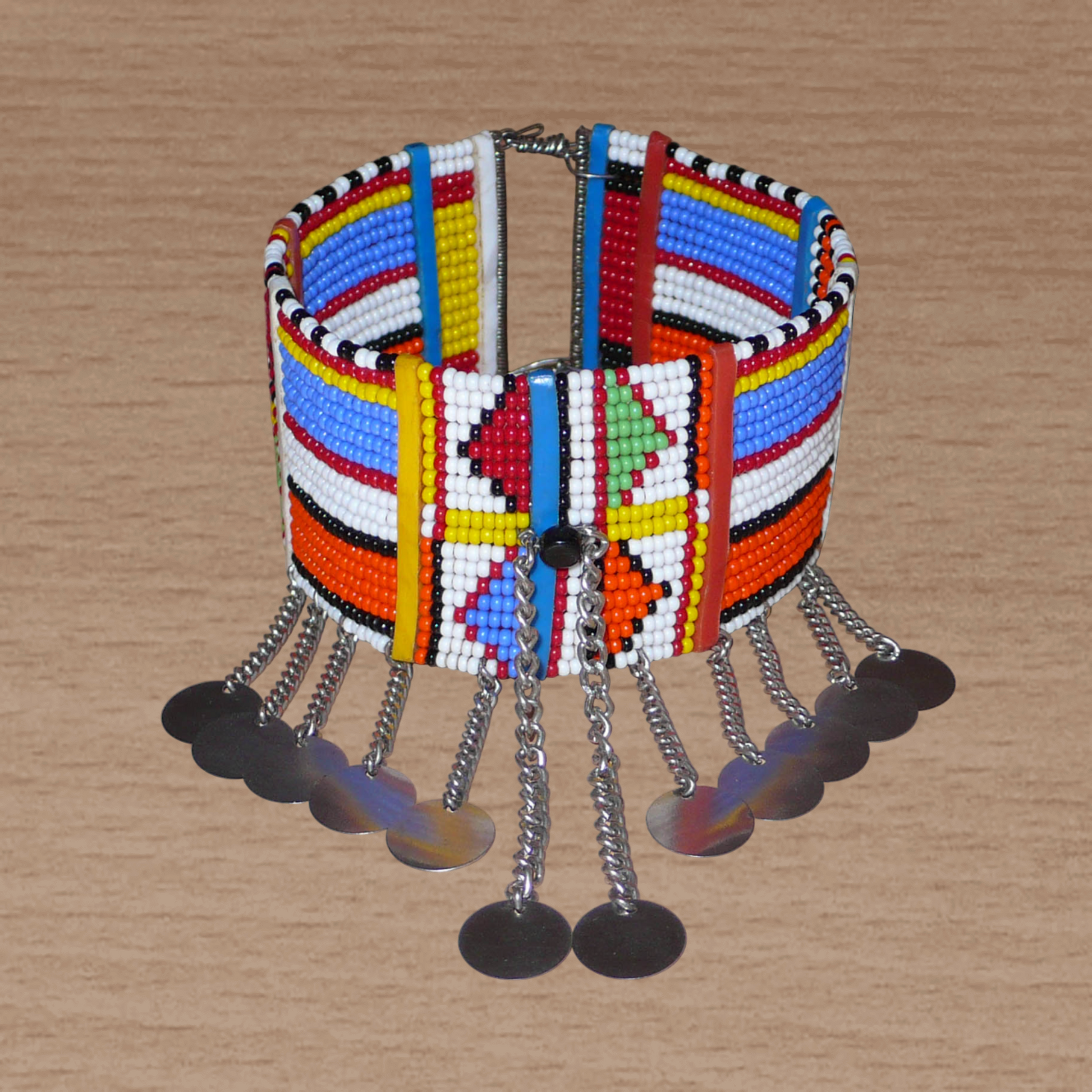 Authentique bracelet africain de cheville à motifs tribaux Massai composé de dix-huit rangées de perles de rocaille, et décoré de chaînettes ornées de disques métalliques.