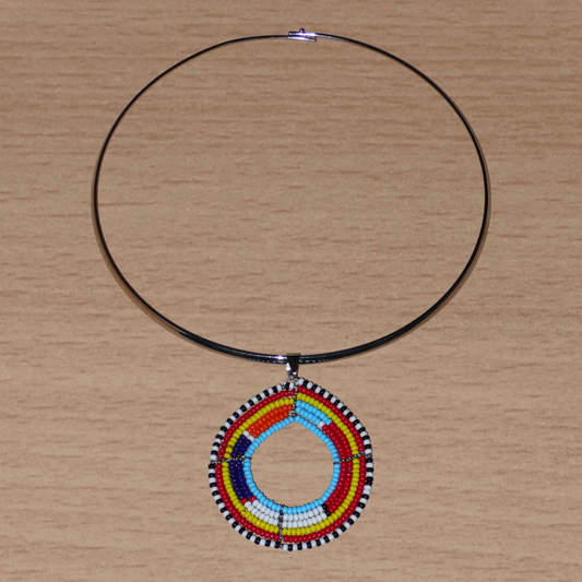 Collier africain composé d'un ras de cou en laiton rehaussé d'un médaillon Massai à motifs ethniques fait de perles de rocaille colorées.