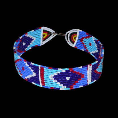 Collier ras de cou africain à motifs ethniques Massai composé de douze rangées de perles de rocaille principalement bleues rouges et blanches ; il se ferme avec un crochet.