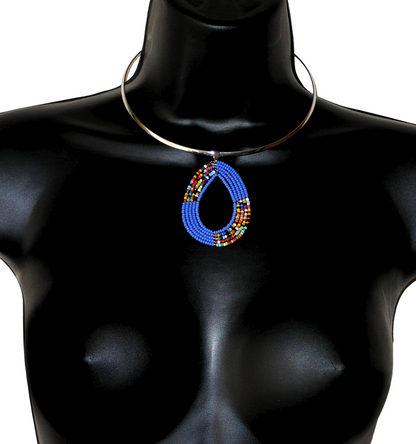 Collier bleu composé d'un ras-de-cou en laiton argenté orné d'un pendentif fait de perles de rocaille bleues et multicolores enfilées sur cinq rangs de fils de fer montés en forme de goutte. Ce collier mesure 19,5 cm de long (de la nuque au bas du pendentif), la cironférence du ras-de-cou est de 42,5 cm et 13,5 cm de diamètre ; le pendentif mesure 6 cm de long et 4,5 cm de large.