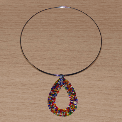 Collier ethnique contemporain composé d'un ras de cou en laiton orné d'un pendentif fait d'un mélange de perles de rocaille multicolores translucides montées en forme de goutte.