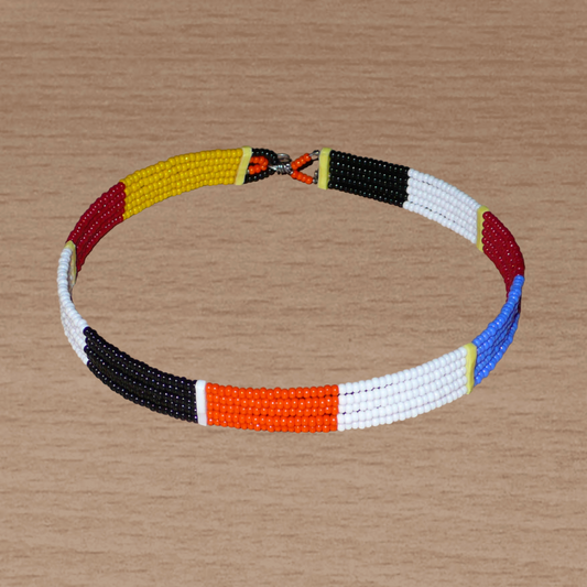 Collier ras de cou africain Massai fait de cinq rangées de perles de rocaille orange, noires, blanches, rouges et jaunes. Sa longueur autour du cou est de 35,5 cm et sa largeur de 1 cm ; il s'attache avec un crochet.