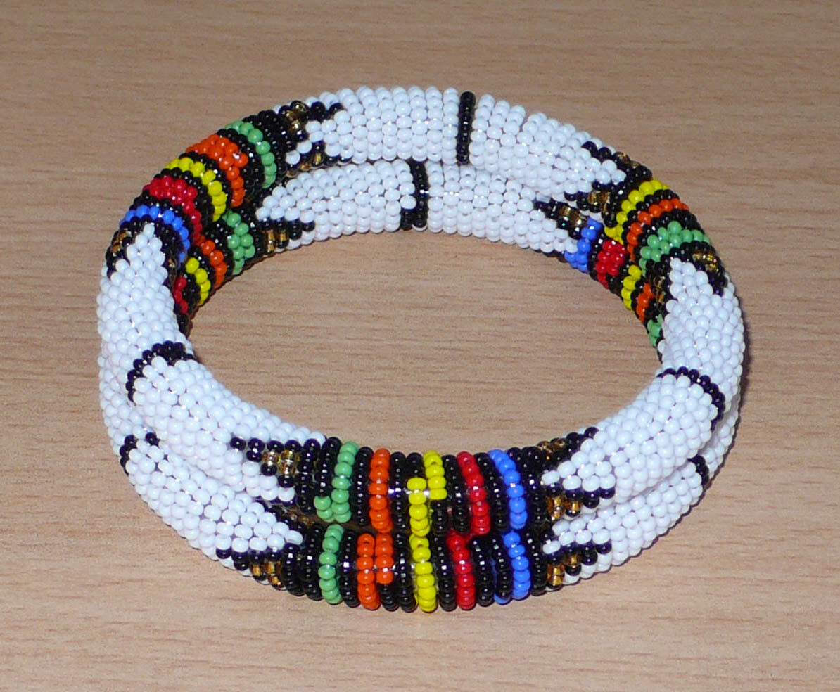 Lot de deux bracelets africains à motifs zoulous traditionnels, composés de perles de rocaille blanches et multicolores.