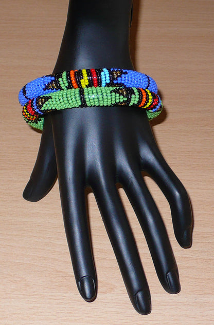 Lot de deux bracelets tubulaires de tradition sud-africaine zouloue, composés de perles de rocaille bleues pour l'un et vertes pour l'autre, et de perles multicolores pour les motifs.