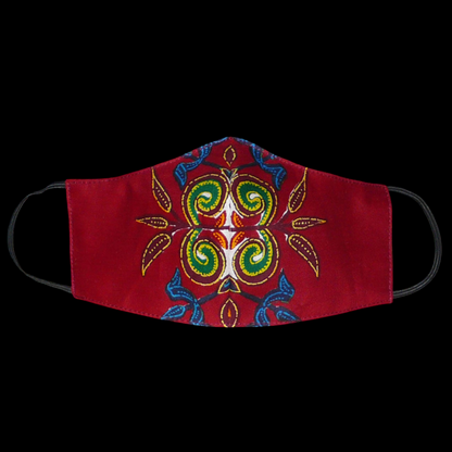Masque en tissu africain bordeaux imprimé de motifs exotiques floraux multicolores, à porter avec des élastiques. Conçu dans l'optique d'une utilisation éco-responsable, ce masque est lavable et réutilisable.