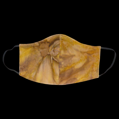 Masque facial textile à la coupe ajustée, cousu dans un tissu en coton imprimé Tie and Dye aux nuances de couleurs marron, beige et jaune ; il se porte avec des élastiques. En vue d'une utilisation eco-friendly, ce masque est lavable et réutilisable.