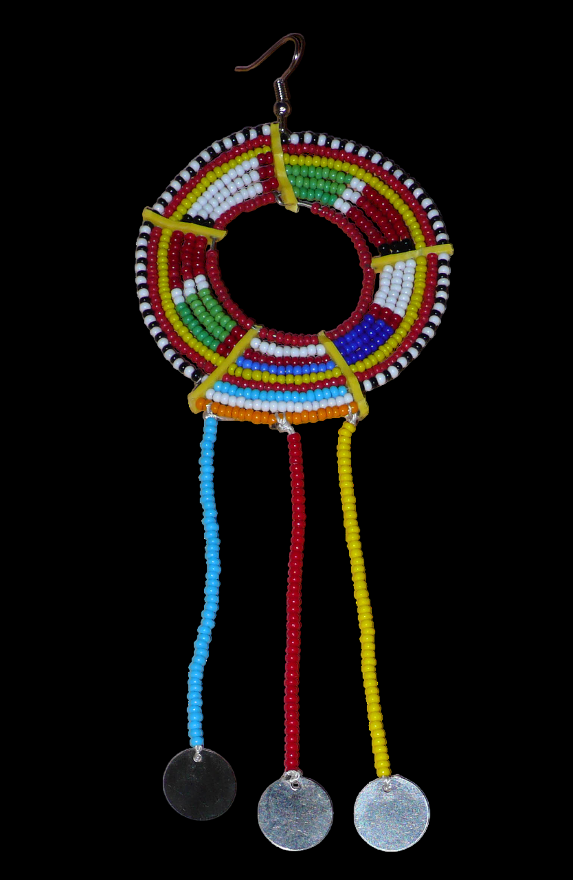 Pièce unique composée de perles de rocaille rouges et multicolores, cette mono boucle d'oreille à franges, confectionnée au Kenya dans la plus pure tradition Massai, est un bijou à porter d'un seul côté, qui apportera à votre look une touche éclatante d'asymétrie visuelle. Surdimensionnée, cette mono boucle au style exotique mesure 16 cm de long et 6 cm de large, et se porte avec un crochet en acier inoxydable sur une oreille percée.